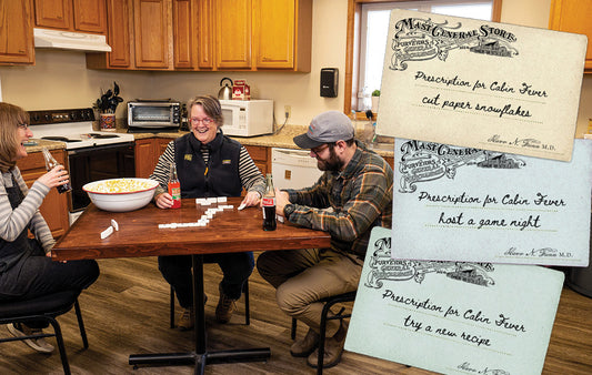 Three people sitting around a table on game night
