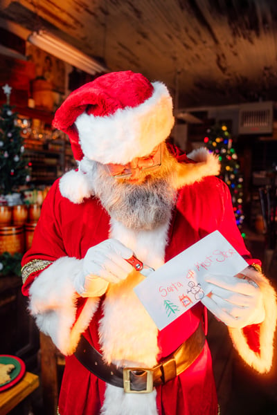 Santa opens a letter from a young fan